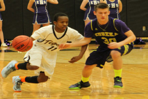 Marquis Pepper (11) brings the ball up the court in a game against Eureka earlier this season. 
