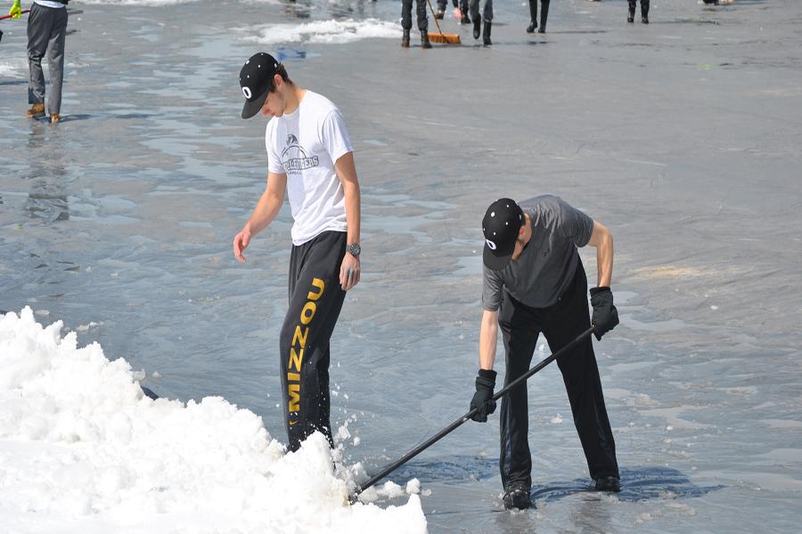 Boys shovel off the baseball field last spring break after a snow storm late last March. 