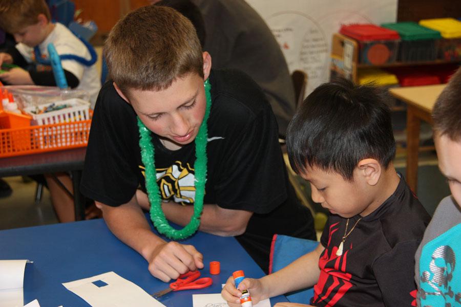 John Pybas helps a young student at Bierbaum Elementary in Mrs. Buckleys class.  