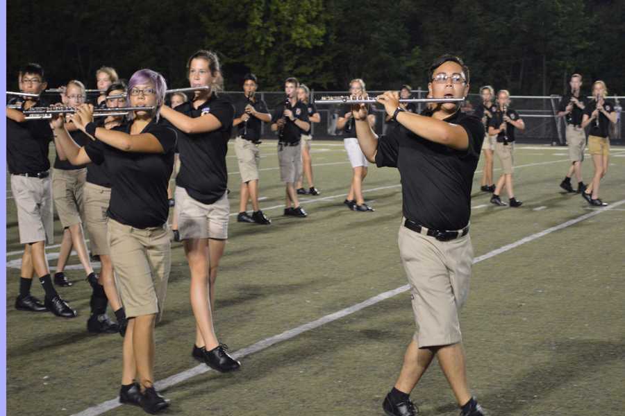 The members of the OHS marching band and color guard perform at halftime at the varsity football game against Eureka on Aug. 29.