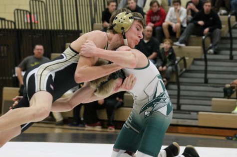 Caleb Schrader (9) wrestles a Lindbergh High School opponent and tries to pin him down.