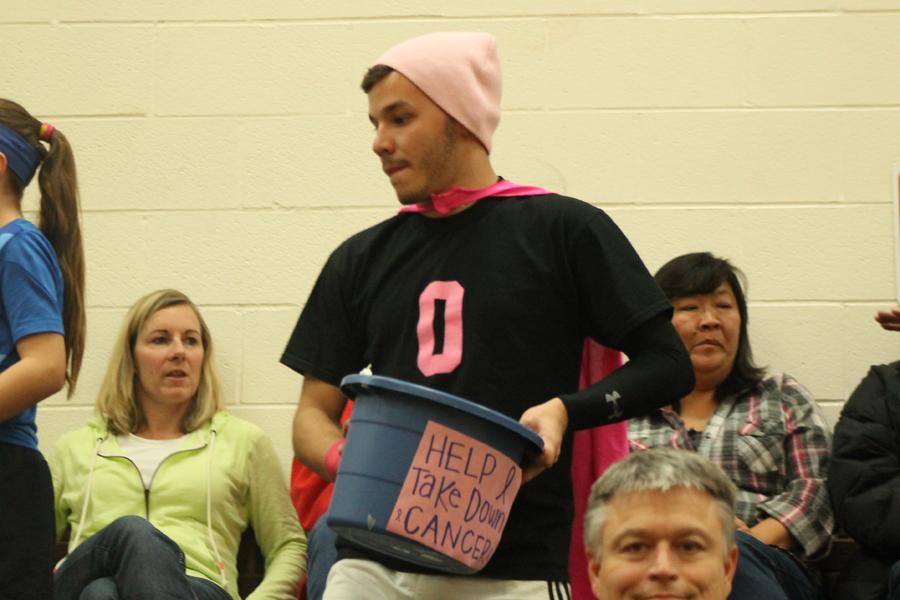 Eric Tate (12) collects money at the annual Pink Out basketball game. 