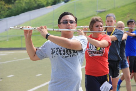 Donald Rabin (12) practices the flute during marching band practice. Rabin was chosen for the MMEA First-Chair Flute in the 2014-2015 school year. 