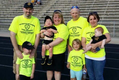 OHS teachers Mrs. Jackie Neeley and Mr. Matt Schraut are shown with their families. Varsity soccer and baseball teamed up with Lindbergh to raise money for PKS and Downs Syndrome research in honor of Neeley and Schrauts sons.