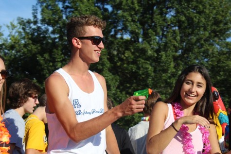 Griffin Bailey (12) shoots Paige Pommer (10) with a water gun during the annual Homecoming Parade. 
