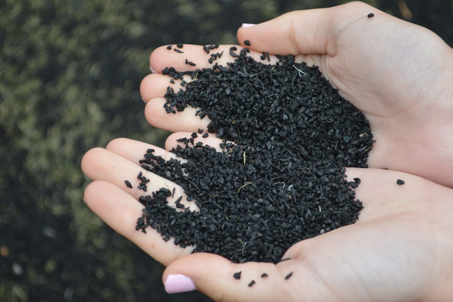 The turf field consists of mainly black rubber pellets, which conceal the green fibers on the field. 