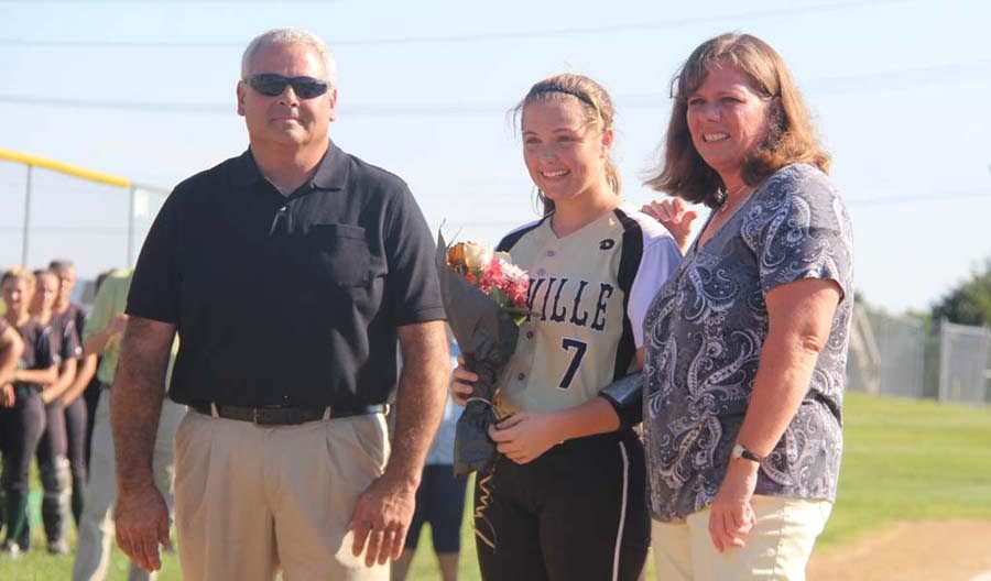 Emily Davidson (12) stands with her parents on Senior Night on Sept. 22.