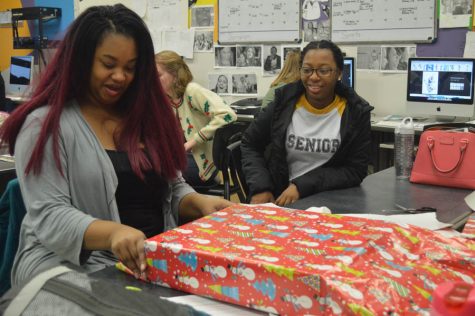Students help wrap gifts for the Community Care Project. 