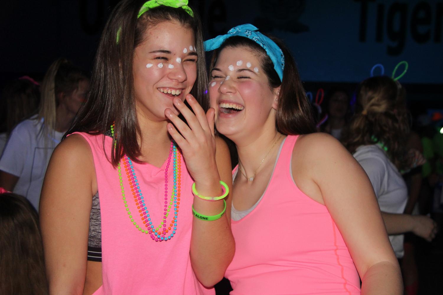 Laughing side by side, Cat Elking (11) and Ashley Jakubeck (12) enjoy their time at the Dance for Charity Neon Night.