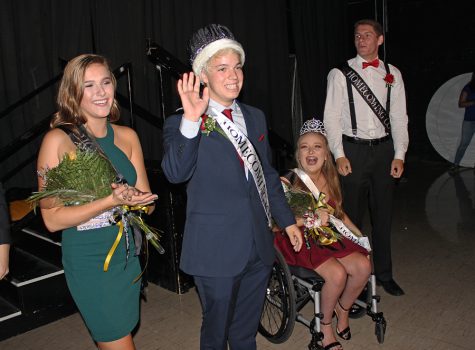 With fellow court members Abbi Baker (12), Queen Sophia Martino (12), and Brad Hartmann (12), JP Latreille (12) waves at the crowd after being crowned.