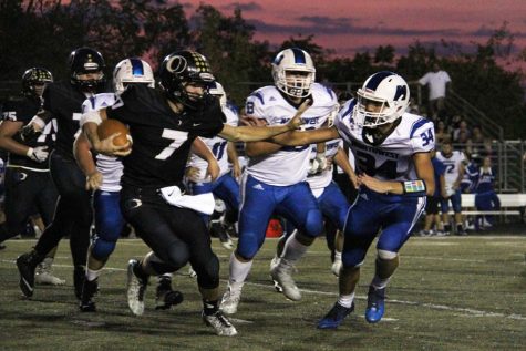 Quarterback Jordan Jost (12) carries the ball at the Sept. 8 homecoming game. OHS won 17-7.
