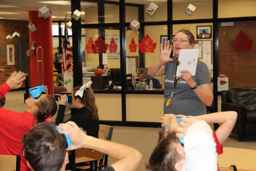 Ms.Pfeifer instructs her students as they use the new vision glasses on Sept. 29.