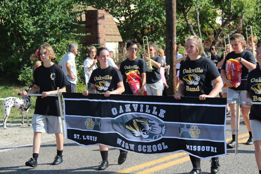 Carrying their banner, Marching band marches in the homecoming parade on Sept. 8.