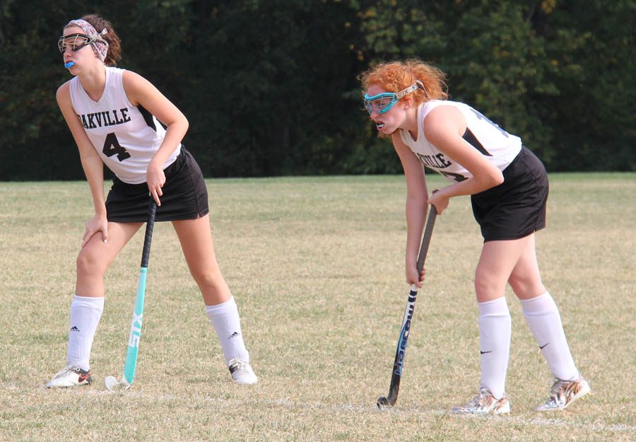 Caitlyn Kelly (12) and Morgan Allen (11) prepare for the ball to drop on Sept. 13 against Cor Jesu.