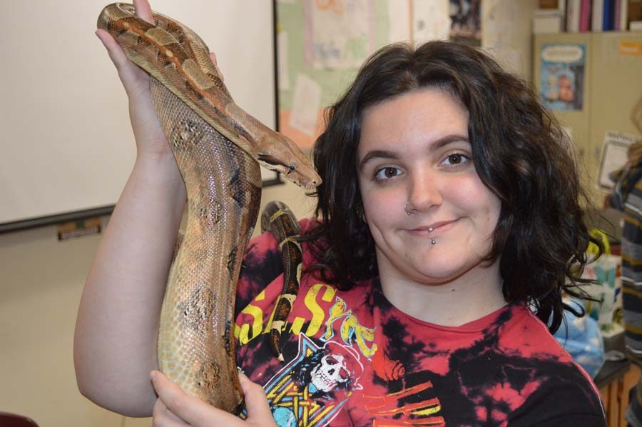 Lauren Boitano (10) poses with her boa constrictor that she brought to science club on Oct. 30.