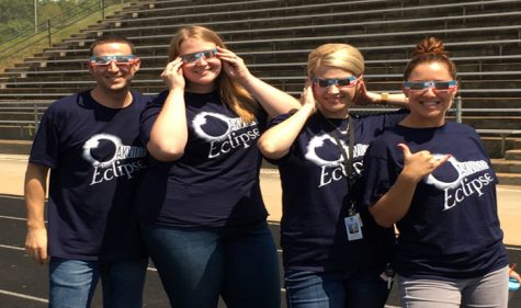 New english teachers Matthew Holborow, Katie Wolf, Amy Crean, and Natalie Jeney show off their Eclipse wear on Aug. 21 on the OHS football field.