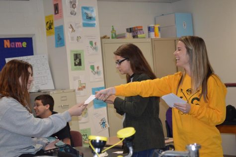 Smiling at her student, science teacher Ms. Kelsey Tuntze hands Allison Harvey (12) her personalized note during ANP on Oct. 27.