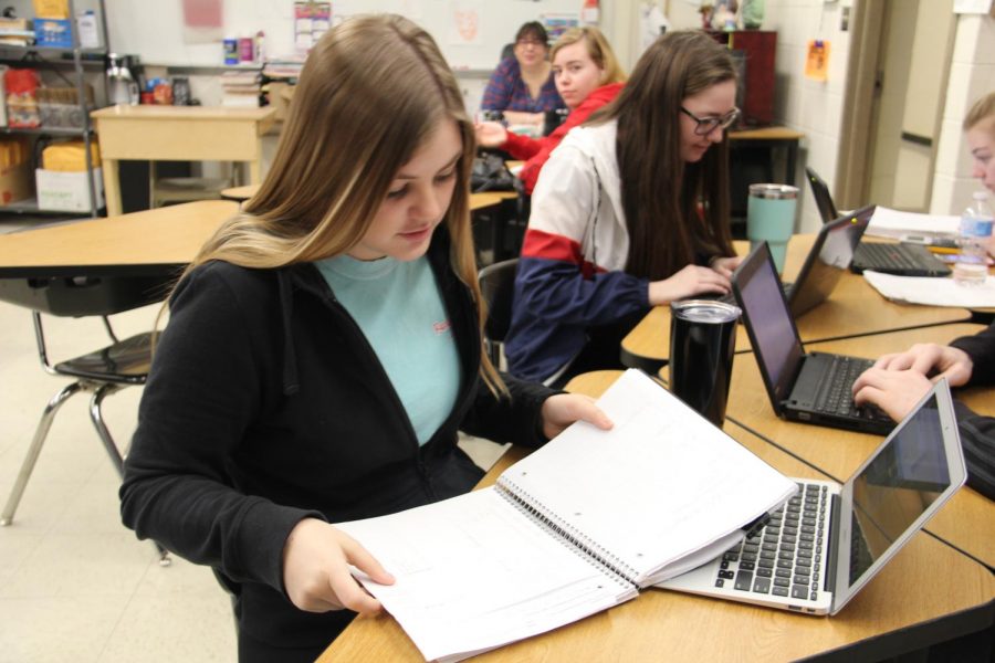 Madi Strohm (12) flips through her notes in Mrs. Quesenberrys ANP as she works on her homework on Feb. 14.