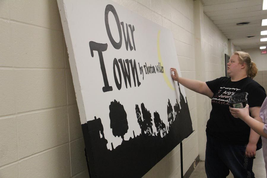 Frances Lavall (11) works on creating the sign for the play, Our Town, on Feb. 7.