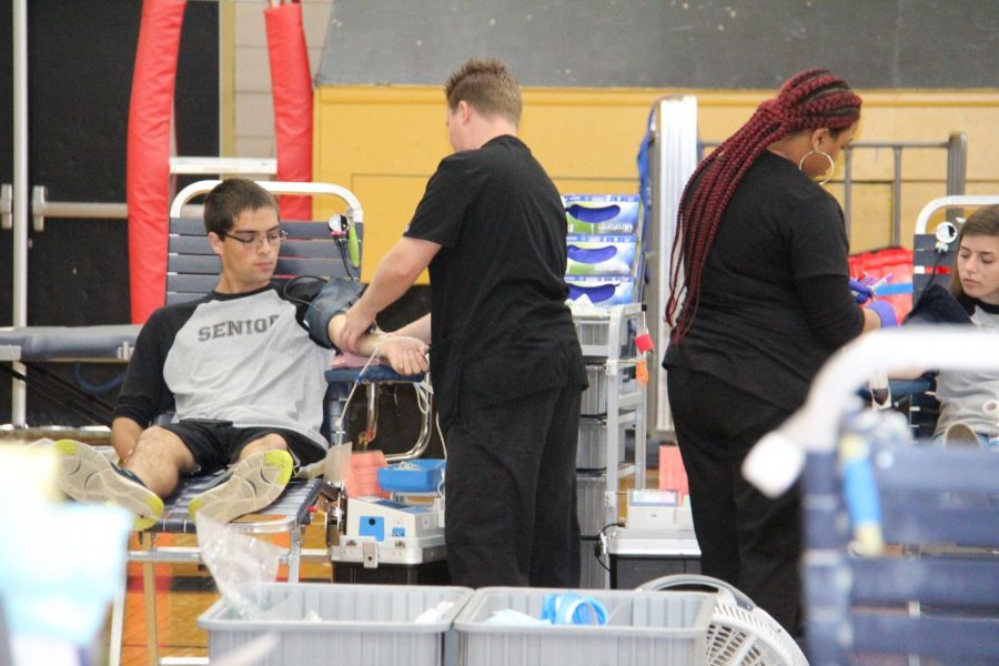 Greg Davidson (12) donates blood during OHS blood drive.