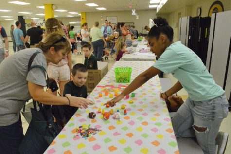 Kayla Jackson (10) interacts with a child and his mom at the 2017 STUCO Easter Egg Hunt.
