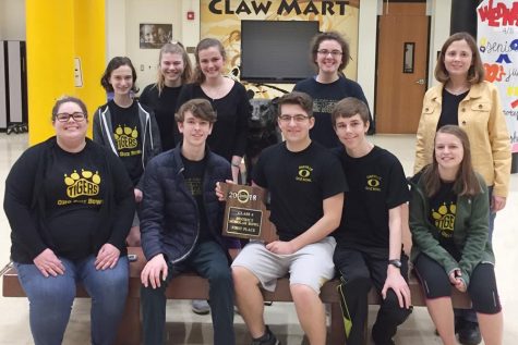 The Academic Quiz Bowl team poses for a picture with their hardware.