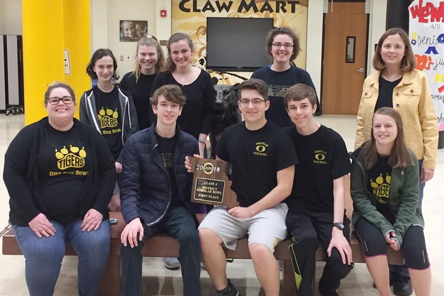 The+Academic+Quiz+Bowl+team+poses+for+a+picture+with+their+hardware.