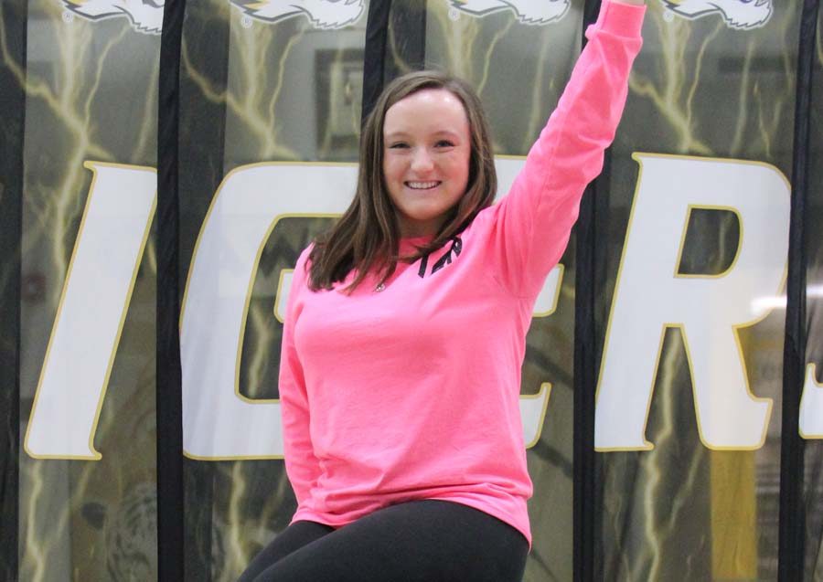 Taylor Zapf (12) poses on top of the tiger statue in the commons.