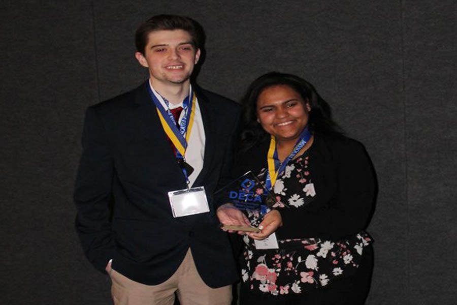 Sean Maltagliati (12) and Sierra Uko (12) pose for a picture after being awarded the opportunity to attend Nationals.