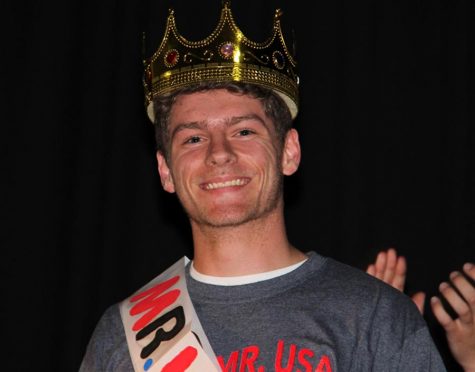 Mr. DECA Brad Hartmann (12) smiles with his crown.