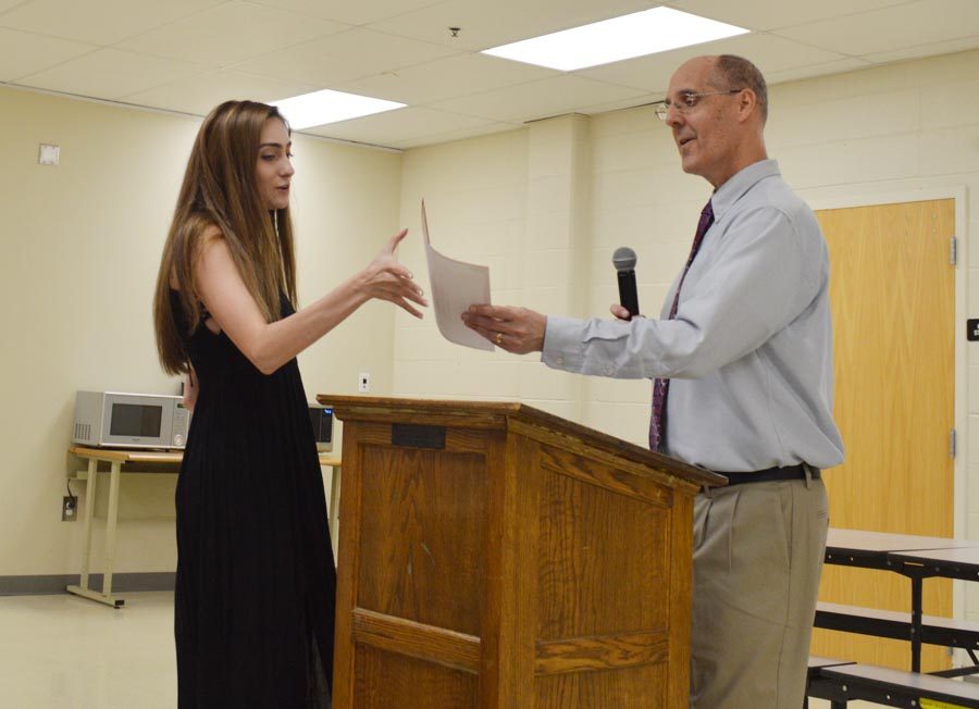 Melanie Neff (12) receives her award at the Journalism banquet on May 16.