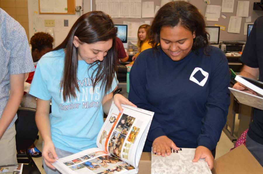 Yearbook Editors in Chiefs Rachel Delgado (12) and Sierra Uko (12) smile in amazement as they see the book for the first time on April 26.