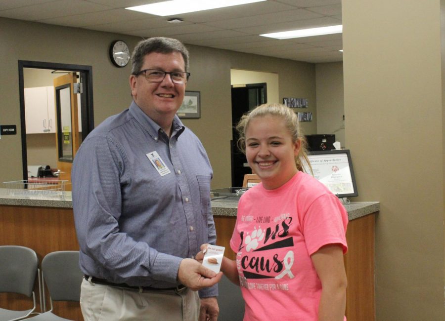 Madi Chiodini (10) receives her birthday gift card from principal Mr. Brian Brennan.