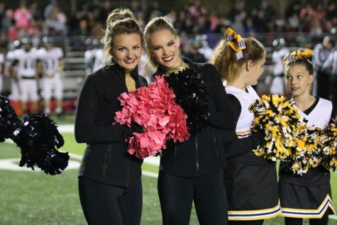 Morgan Murphy (12) and Carolyn Grayson (12) pose together at a home football game.