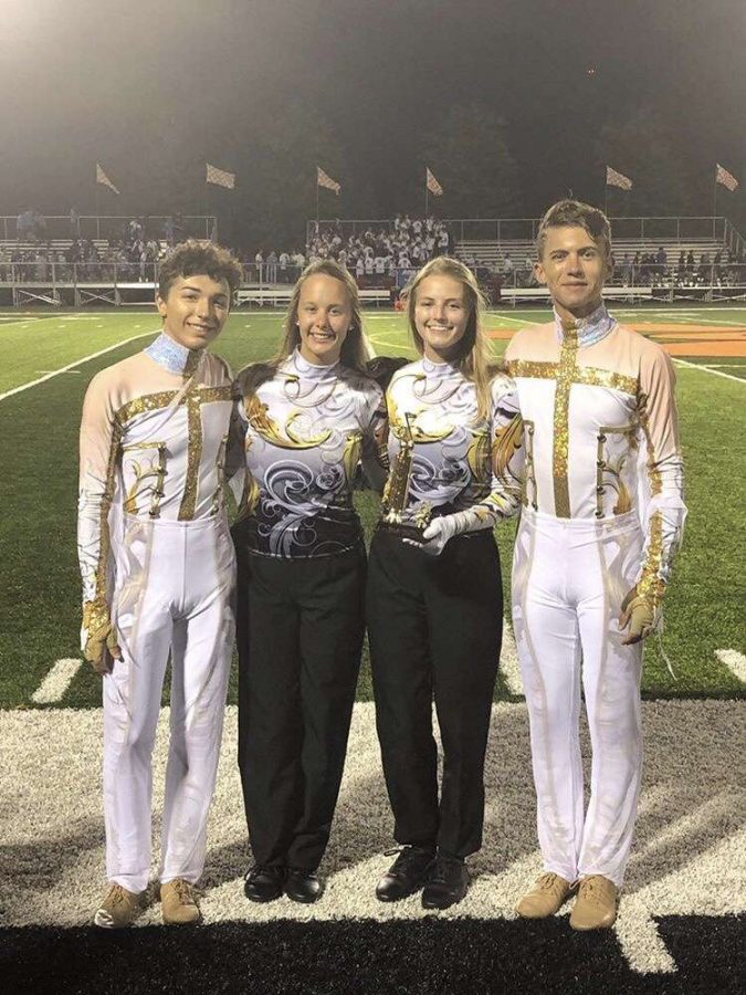 Drum majors Ben Lanier (11), Carley Hopkins (12), and Kayla Cormack (12) hold the trophy with  sophomore color guard captain Andrew Blanchette.