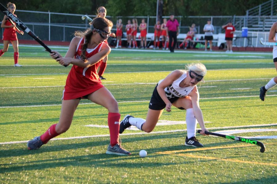 Emma Rose Seger (11) defends the ball before it gets to the goal.