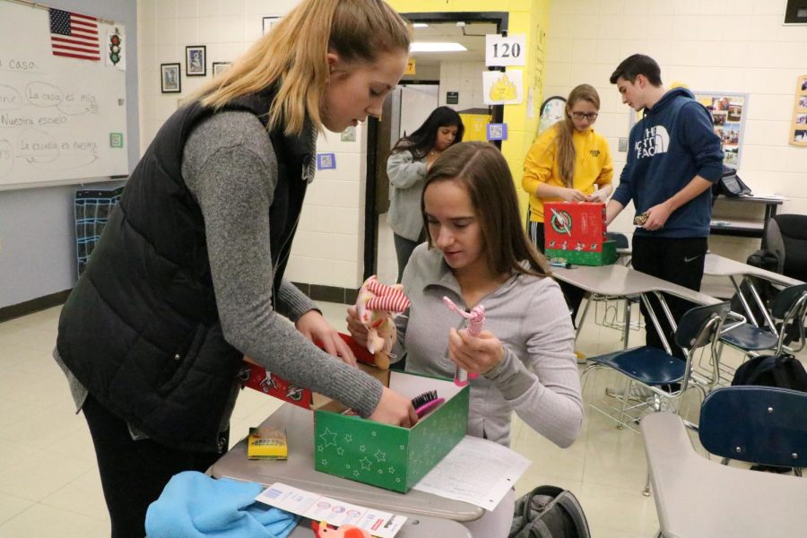 Maddie Brutton (12) and Kayla FitzWilliam (12)  wrap a gift for children in  Central and South America. 