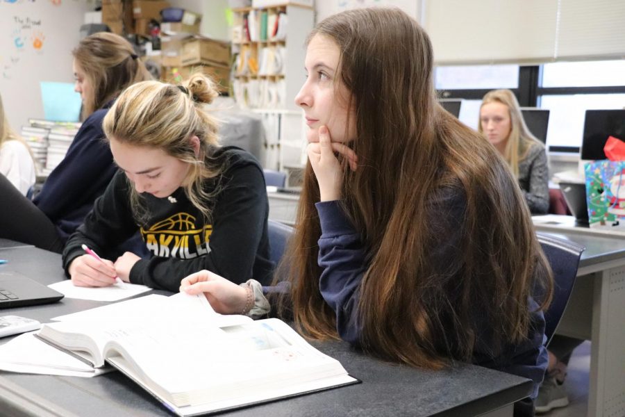 Gabby McMurry (11) studies with an online textbook while Ciara Gallagher (11) uses a physical book.