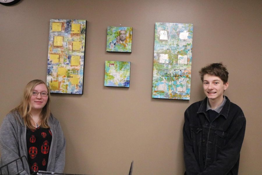 Connor Inman (11) and Abby Degeare (12) pose wit the art pieces they chose for the office.