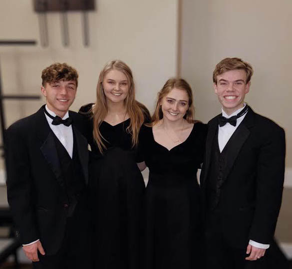 Ben Lanier (11), Riley Hicks (12), Madison Baker (12) and Thomas Schartner (12) pose for a picture after preforming at All-State.