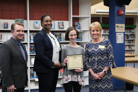 Hanna Franke (11), resieves an award for getting a perfect score on the ACT at the school board meeting on March 12.