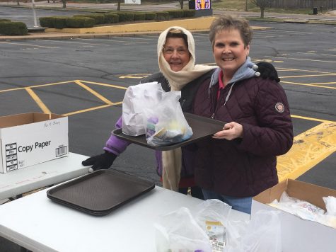 Pam Broz, food manager at Oakville Elementary, and Michelle Kovacich, food manager at Blades Elementary, preparing to distribute meals during the first week of the program at OHS in March. 

