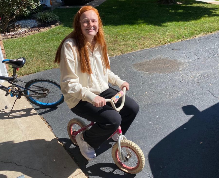 Mackenzie Deutschmann (12) rides her princess bike for the Adventure and Outdoor Pursuits class.
