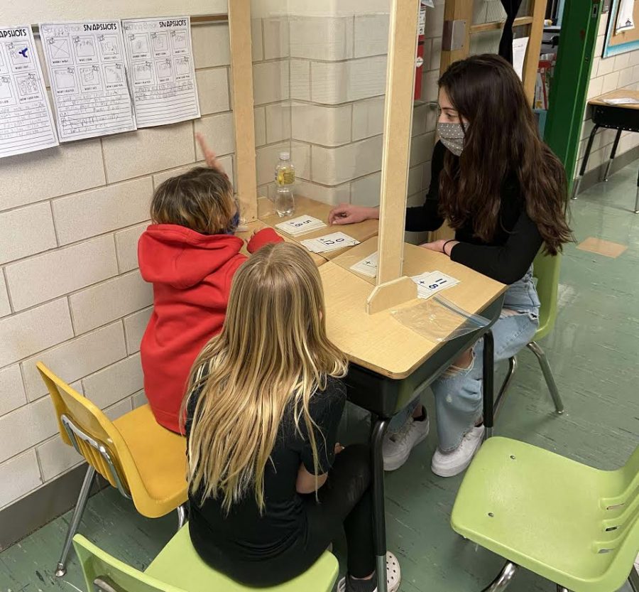 Leyla Vilic (11) tutoring younger students at Wohlwend Elementary. Many A+ tutors have struggled to get their hours in this year with COVID-19 restrictions. 