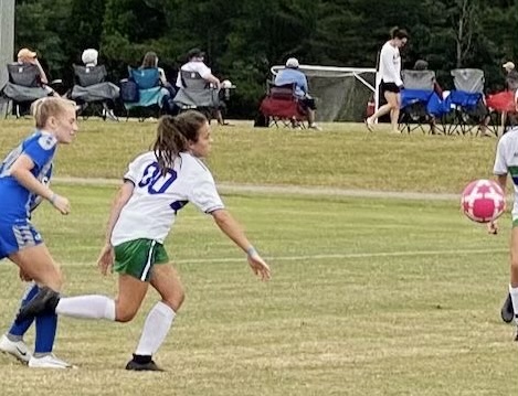 Sophomore Rylee Rafferty (shown in the white) plays soccer for her former select soccer team, the Steamers. “I think that we all help each other and motivate each other to improve,” Rafferty said. “The coaches help us at practice and give us guidance in not only the game but in our lives.” Rafferty hopes to try out for a different soccer team this summer, but says that she will always cherish the Steamers.