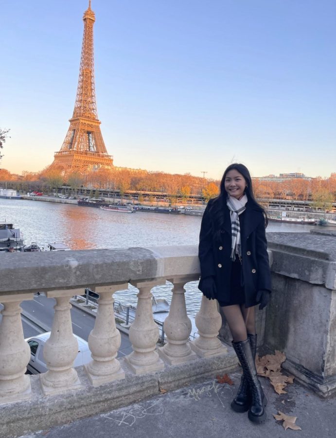 Jasmine Quach (12) poses for a picture in front of the Eiffel Tower in Paris, France in 2021.