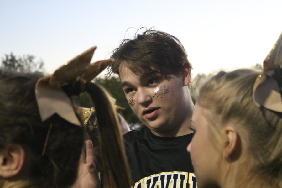 Drew Murphy (11) hypes up the cheer team at the Homecoming football game Sept. 30. “...The hype circles like we see on the intro, me dancing with them and doing everything like that, I think that really gets them elevated and just excited to be out there and do what they love,” Murphy said. The team cheers at a soccer or football game every Friday. 