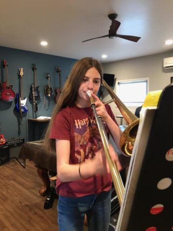 Maura Niebrugge (9) practices her trombone at her own home. “Everyone assumed I was gonna do band…” Niebrugge said. Niebrugge is in Honors Band, which requires a lot of time and effort.