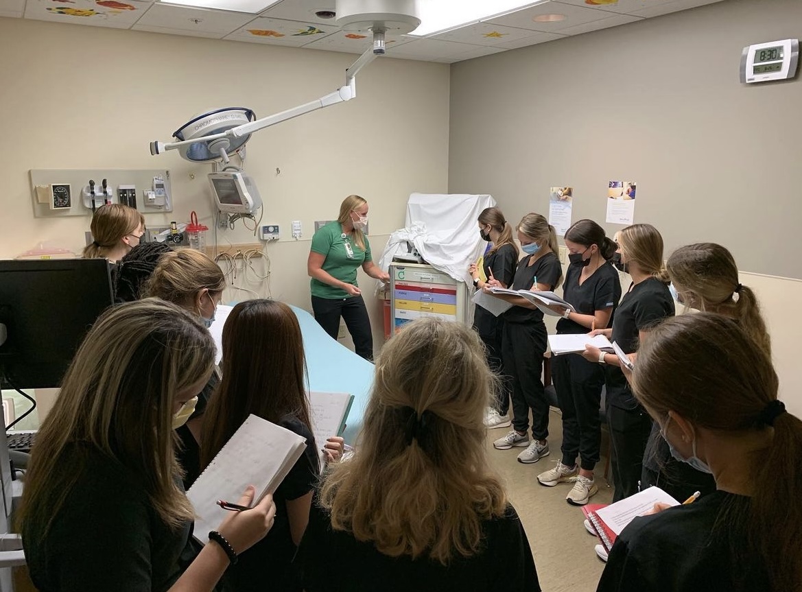 STL CAPS students take notes as the pediatric nurse shows them the crash cart Oct. 2 at Mercy South Hospital. “Taking notes allows me to refer back to them on our projects,” Delic said. The students got to experience patient care firsthand later on.
