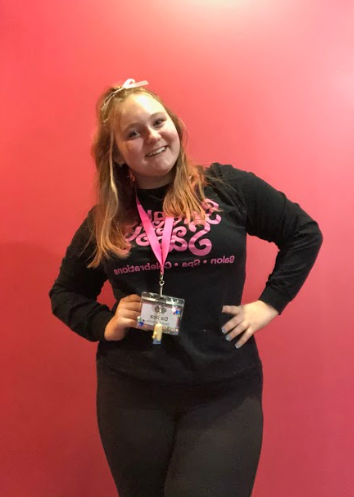 Sophomore Danica Bettis poses in her work uniform at Sweet & Sassy. “I really like it because it’s totally my style,” Bettis said, “like hair, makeup, nails [and] beauty.” Bettis doesn’t think she would find a better job than Sweet & Sassy.